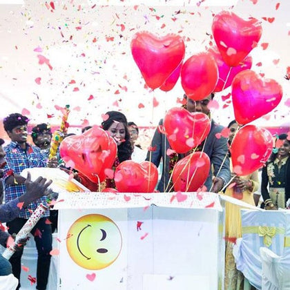 balloon surprise box online india, surprise balloon box delivery, a girl opening her helium balloon surprise box gift delivered by her boyfriend or loved ones