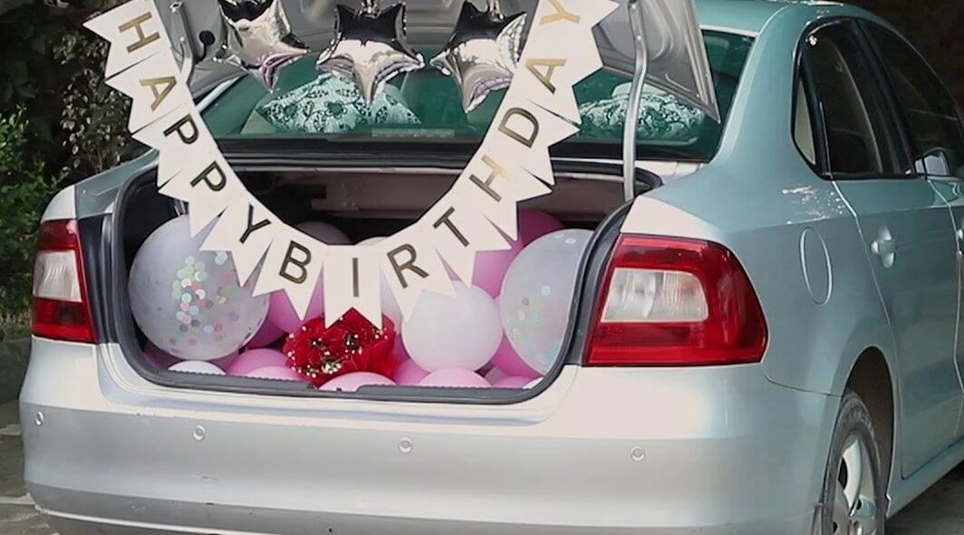 car back birthday surprise with balloons, decorations, happy birthday banner and cakes and flowers, best car birthday surprise decoration